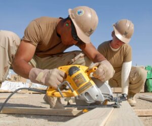 091017-N-9564W-095HELMAND PROVINCE, Afghanistan (Oct. 17, 2009) Construction Electrician 2nd Class Daniel Arteche, left, from Santa Rosa, Calif., and Construction Electrician 2nd Class Alyssa Copp, from Somerset, Mass., assigned to Charlie Company of Naval Mobile Construction Battalion (NMCB) 74, cut bracing for a super Southwest Asia Hut at the Camp Leatherneck expansion project. (U.S. Navy photo by Mass Communication Specialist 1st Class Ryan G. Wilber/Released)